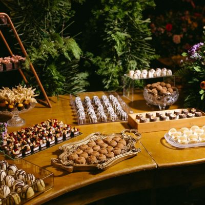 A wooden table topped with lots of desserts